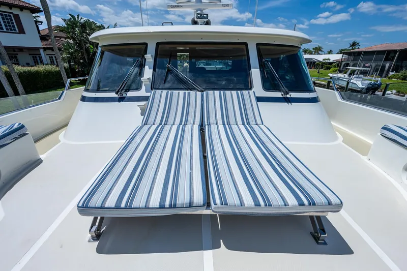 Pivot Yacht Photos Pics 2013 Marlow Explorer Enclosed Bridge (CB) with striped sun loungers on deck.