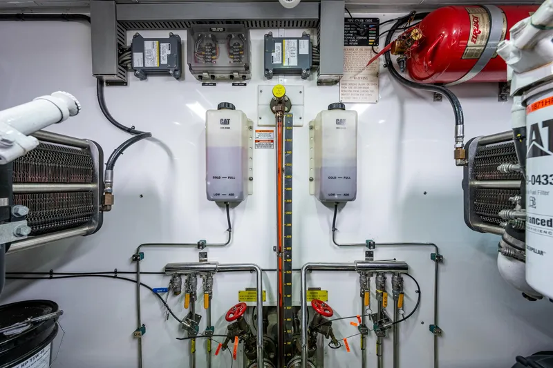 Pivot Yacht Photos Pics Engine room of 2013 Marlow Explorer Enclosed Bridge (CB) yacht, featuring CAT machinery and fire suppression system.