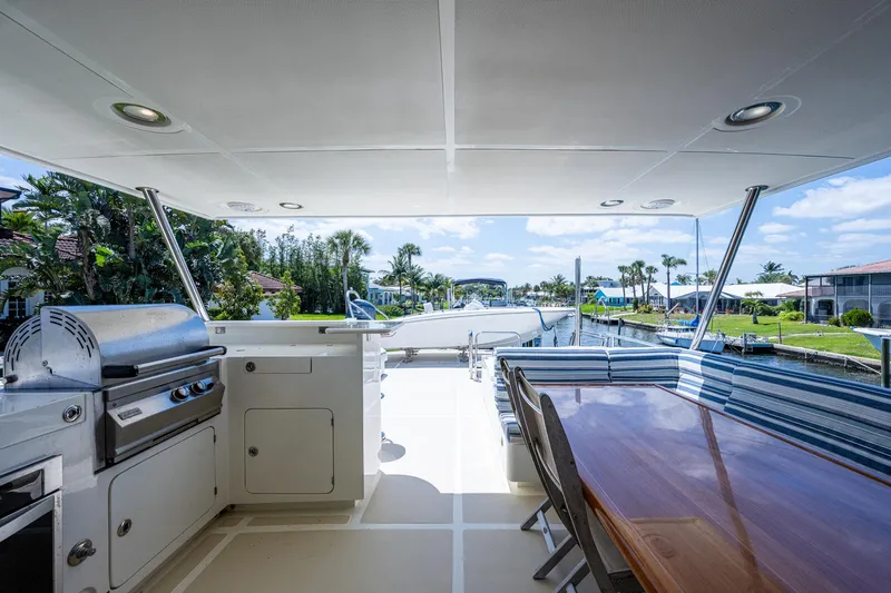 Pivot Yacht Photos Pics 2013 Marlow Explorer Enclosed Bridge CB yacht deck with outdoor kitchen and dining area.