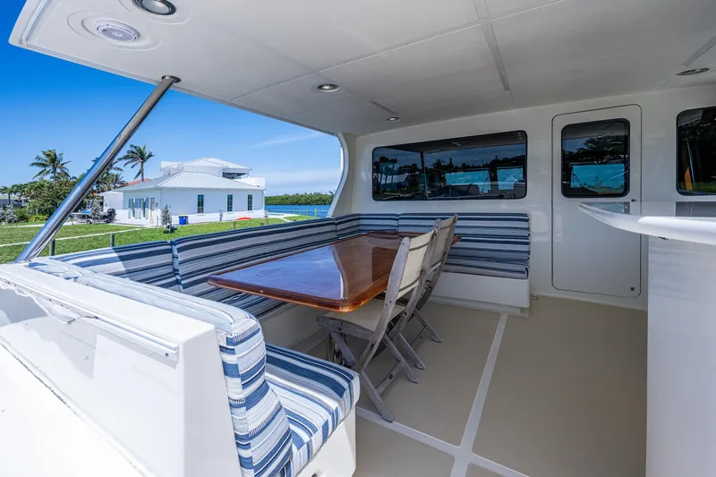 Pivot Yacht Photos Pics 2013 Marlow Explorer Enclosed Bridge CB yacht with outdoor seating and dining area.