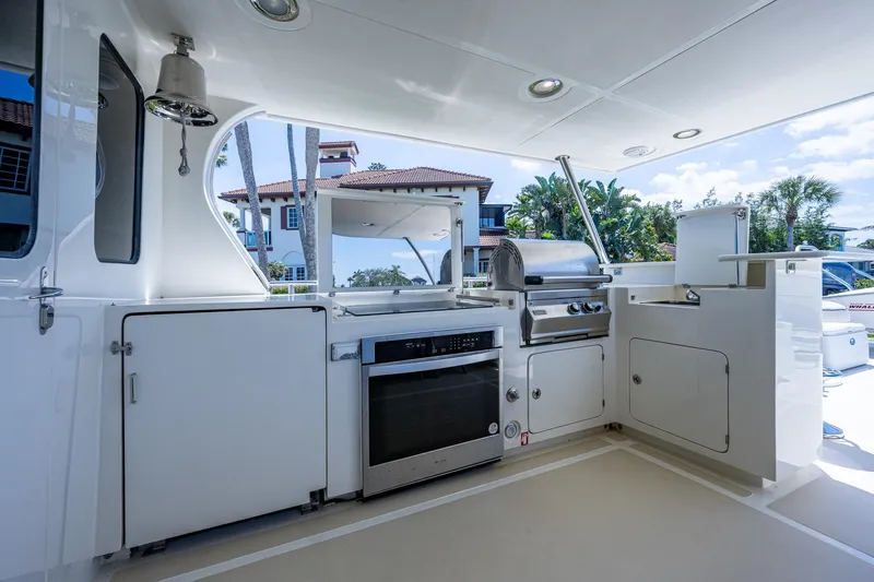 Pivot Yacht Photos Pics Outdoor kitchen on 2013 Marlow Explorer Enclosed Bridge yacht with grill and oven.