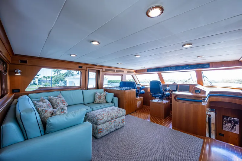 Pivot Yacht Photos Pics 2013 Marlow Explorer Enclosed Bridge CB interior with blue sofa and helm station.