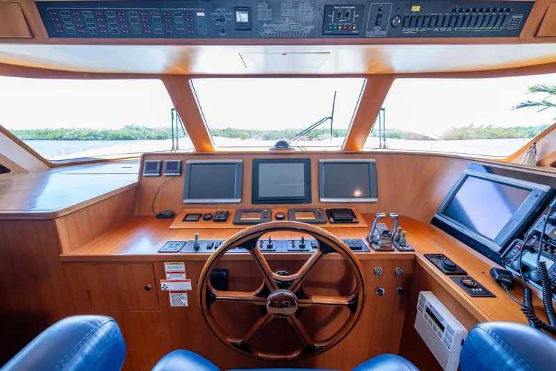 Pivot Yacht Photos Pics 2013 Marlow Explorer Enclosed Bridge (CB) helm with advanced navigation systems and wooden steering wheel.