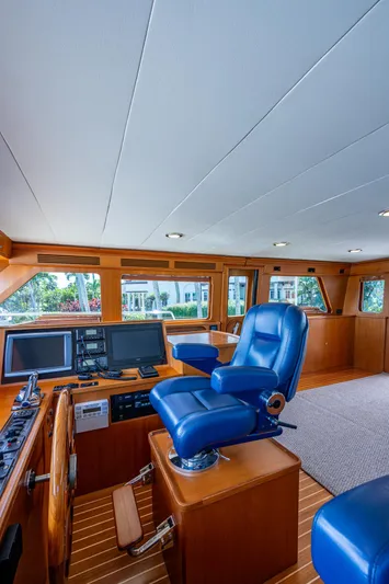 Pivot Yacht Photos Pics 2013 Marlow Explorer Enclosed Bridge (CB) helm with blue captain's chair and navigation equipment.