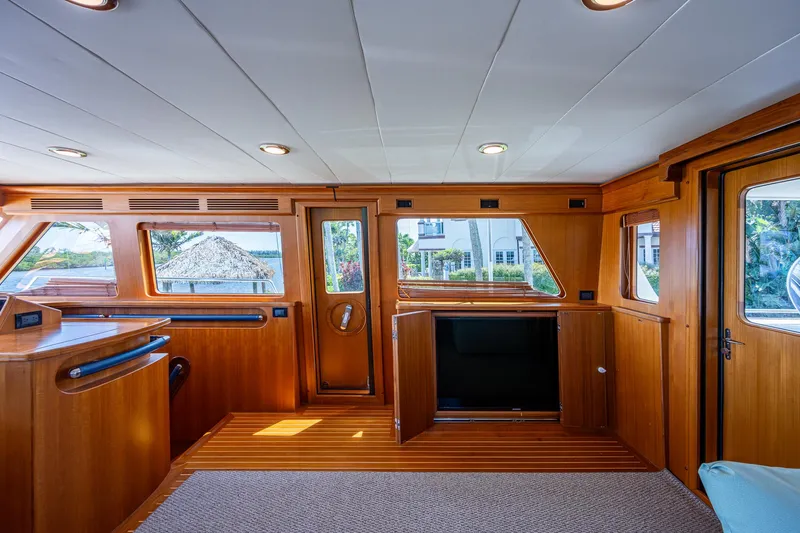 Pivot Yacht Photos Pics Interior of 2013 Marlow Explorer Enclosed Bridge (CB) yacht with wooden finishes and large windows.