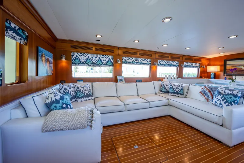 Pivot Yacht Photos Pics Luxurious interior of 2013 Marlow Explorer Enclosed Bridge yacht with white sectional sofa.