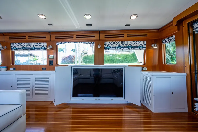 Pivot Yacht Photos Pics Interior of 2013 Marlow Explorer Enclosed Bridge (CB) with wood paneling and built-in TV.