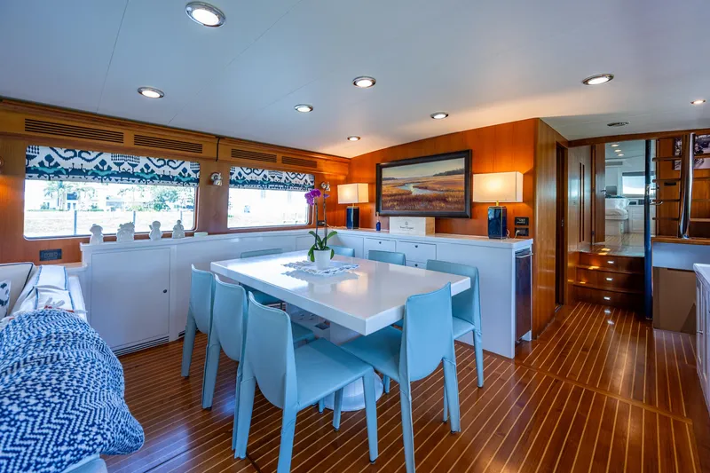 Pivot Yacht Photos Pics Luxurious interior of 2013 Marlow Explorer Enclosed Bridge (CB) yacht with modern dining area.