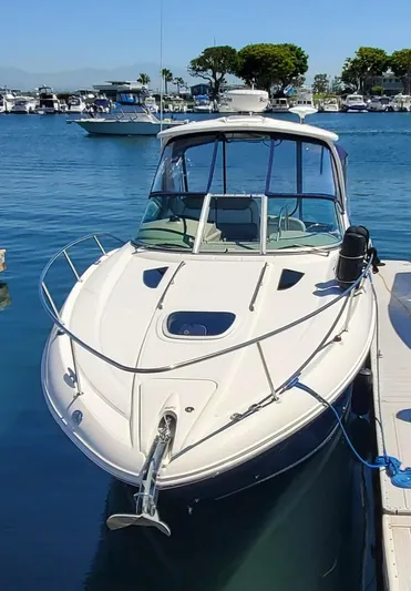 Just Becuz Yacht Photos Pics 2007 Sea Ray 310 Sundancer docked in a marina, clear blue water and sky.