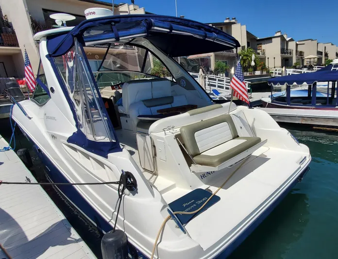 Just Becuz Yacht Photos Pics 2007 Sea Ray 310 Sundancer docked, featuring a spacious deck and American flags.
