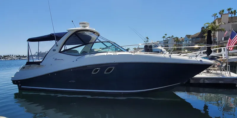 Just Becuz Yacht Photos Pics 2007 Sea Ray 310 Sundancer boat docked in a marina under clear blue skies.