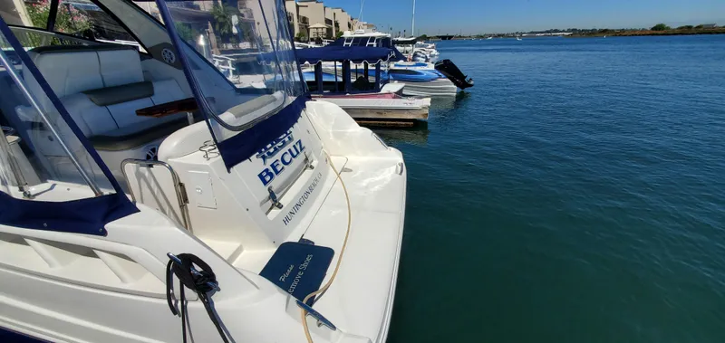Just Becuz Yacht Photos Pics 2007 Sea Ray 310 Sundancer docked at a marina with clear blue water.