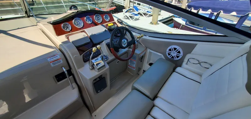 Just Becuz Yacht Photos Pics 2007 Sea Ray 310 Sundancer helm with steering wheel, gauges, and seating.