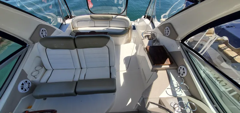Just Becuz Yacht Photos Pics 2007 Sea Ray 310 Sundancer interior with seating and speakers, overlooking water.