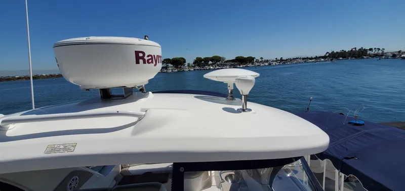 Just Becuz Yacht Photos Pics 2007 Sea Ray 310 Sundancer on calm waters with clear blue sky.