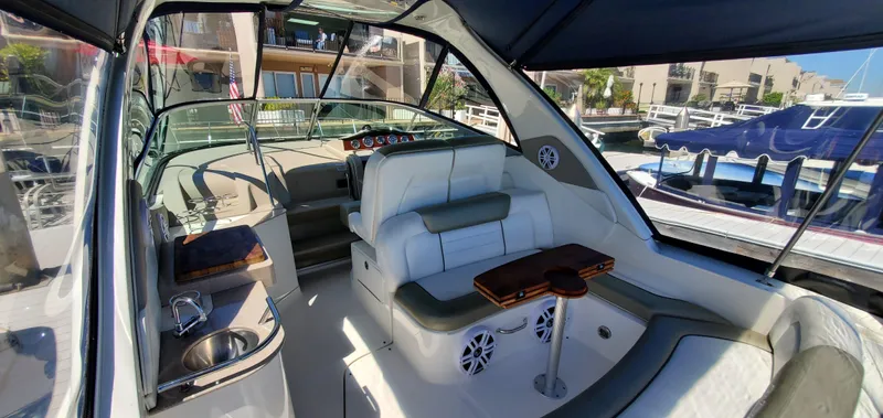 Just Becuz Yacht Photos Pics 2007 Sea Ray 310 Sundancer interior with seating, helm, and marina view.