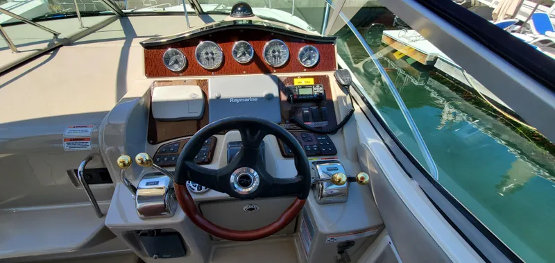 Just Becuz Yacht Photos Pics 2007 Sea Ray 310 Sundancer helm with gauges, steering wheel, and controls.