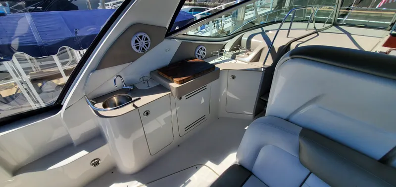 Just Becuz Yacht Photos Pics 2007 Sea Ray 310 Sundancer interior with kitchenette and seating area.