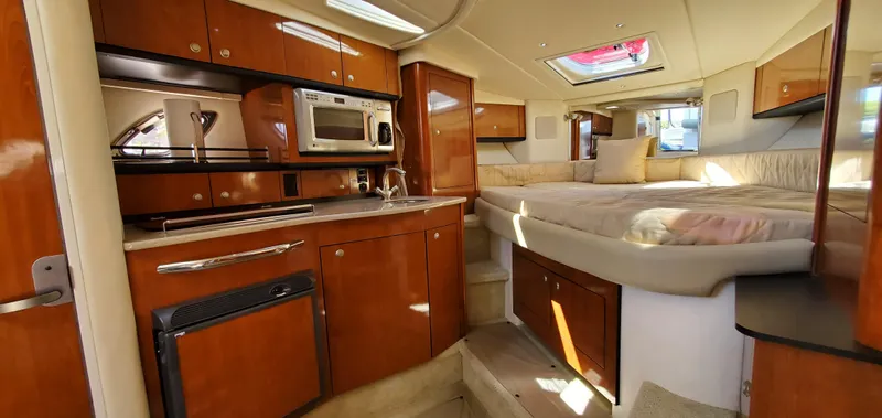 Just Becuz Yacht Photos Pics Interior of 2007 Sea Ray 310 Sundancer with kitchen and cozy sleeping area.