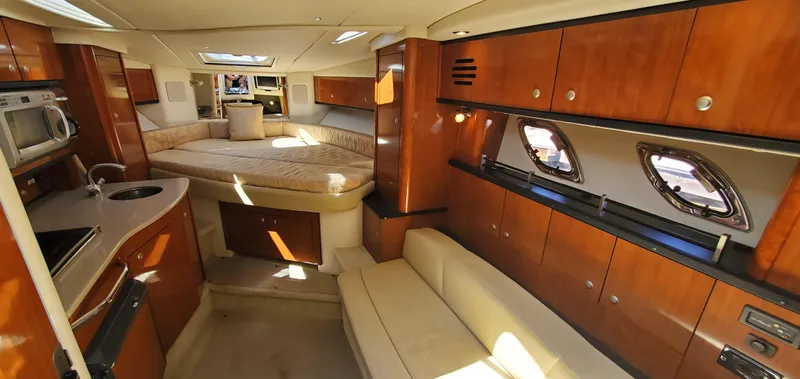 Just Becuz Yacht Photos Pics Luxurious interior of 2007 Sea Ray 310 Sundancer yacht with wood cabinetry and cozy seating.