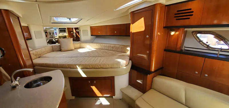 Just Becuz Yacht Photos Pics Interior of 2007 Sea Ray 310 Sundancer, featuring cozy cabin and elegant wood finishes.