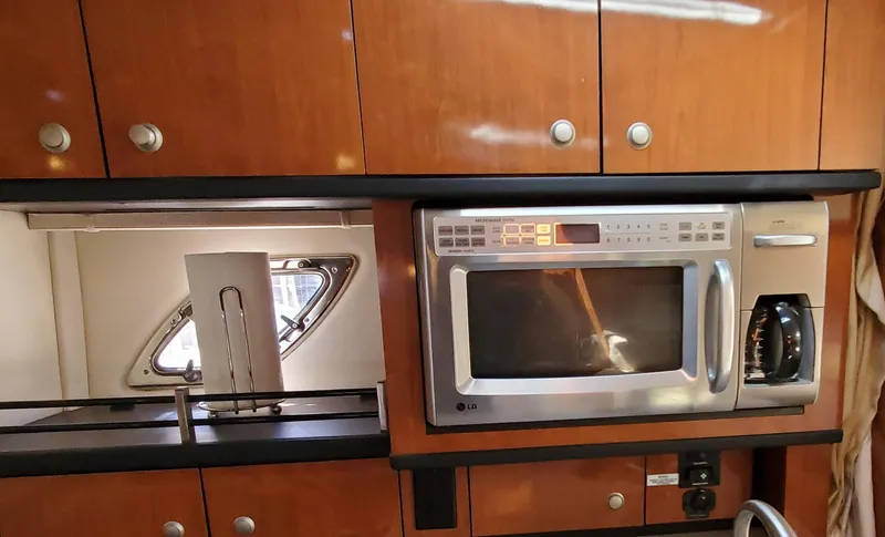 Just Becuz Yacht Photos Pics 2007 Sea Ray 310 Sundancer kitchen with microwave and wooden cabinets.