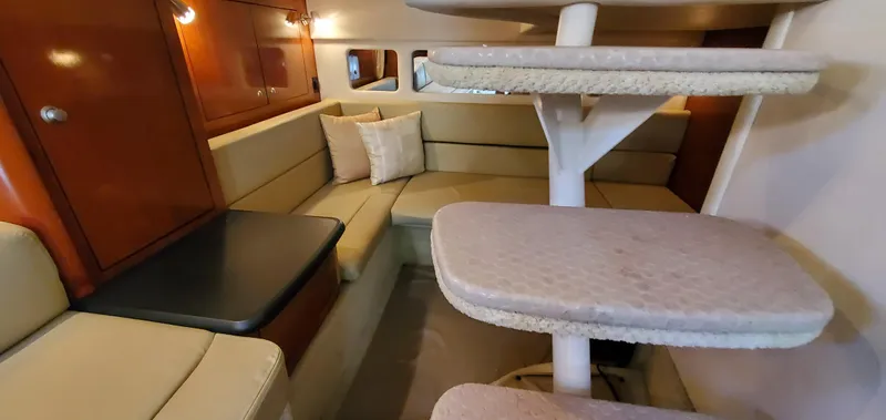 Just Becuz Yacht Photos Pics 2007 Sea Ray 310 Sundancer cabin interior with beige seating and wooden accents.
