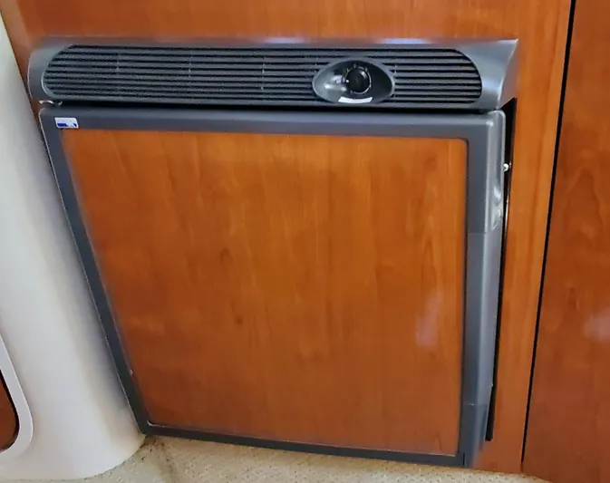 Just Becuz Yacht Photos Pics 2007 Sea Ray 310 Sundancer cabin refrigerator with wooden paneling.