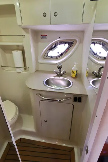 Just Becuz Yacht Photos Pics 2007 Sea Ray 310 Sundancer bathroom with sink, toilet, and porthole window.