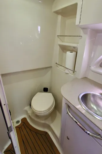 Just Becuz Yacht Photos Pics 2007 Sea Ray 310 Sundancer bathroom with toilet, sink, and wooden floor accents.