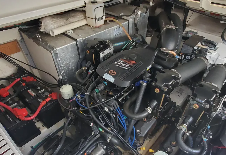 Just Becuz Yacht Photos Pics Engine compartment of a 2007 Sea Ray 310 Sundancer, showcasing detailed mechanical components.