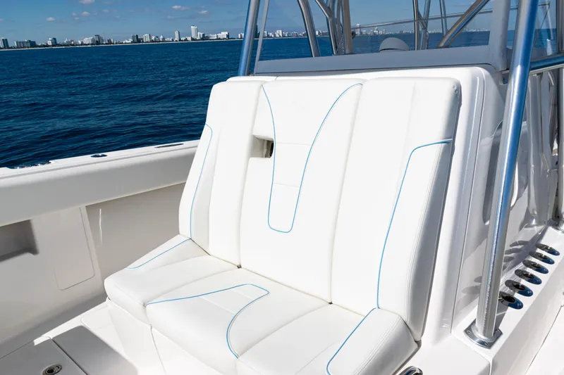  Yacht Photos Pics 2024 SeaVee 390B boat with white cushioned seating, ocean view in background.