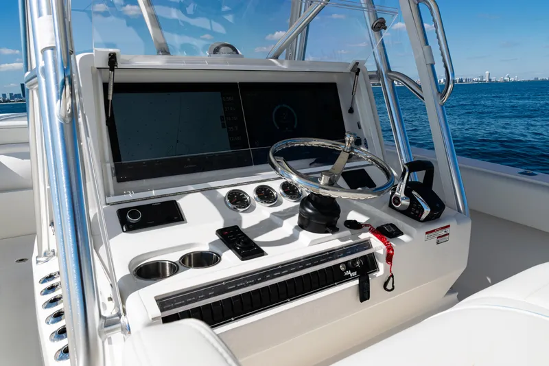  Yacht Photos Pics 2024 SeaVee 390B boat dashboard with steering wheel and navigation controls.