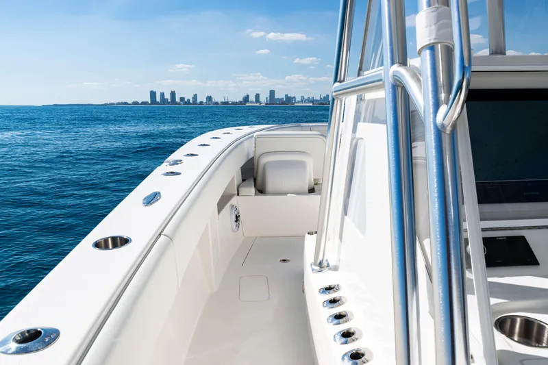  Yacht Photos Pics 2024 SeaVee 390B boat on ocean with city skyline in background.