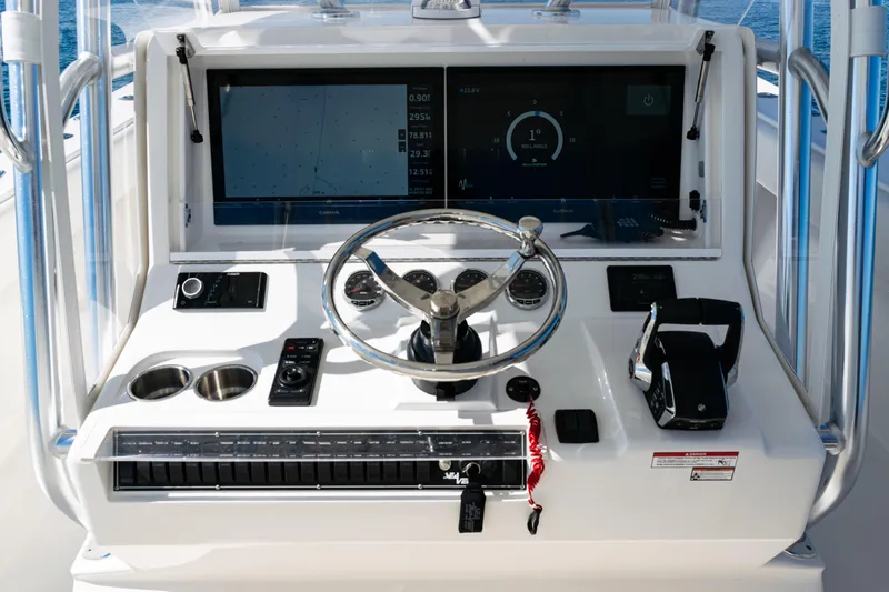  Yacht Photos Pics 2024 SeaVee 390B boat dashboard with steering wheel and navigation display.