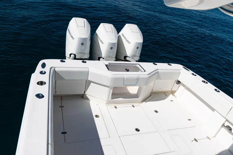  Yacht Photos Pics 2024 SeaVee 390B boat deck with triple Mercury outboard engines on blue water.