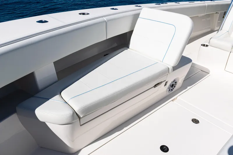  Yacht Photos Pics 2024 SeaVee 390B boat with white cushioned seating and ocean backdrop.