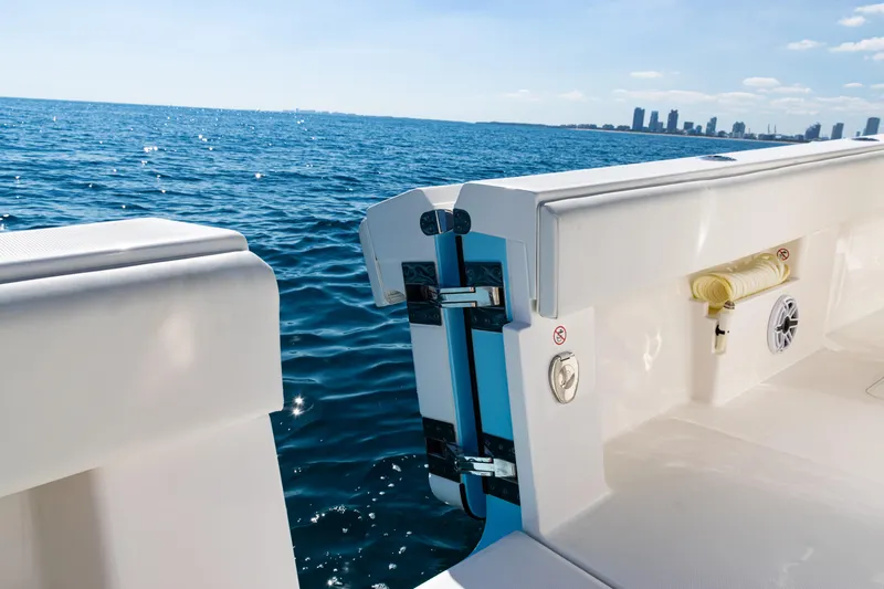  Yacht Photos Pics 2024 SeaVee 390B boat with open transom, ocean view, and city skyline in background.