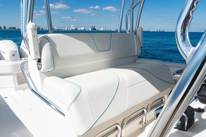  Yacht Photos Pics 2024 SeaVee 390B boat with luxurious seating, ocean view, and city skyline in the background.