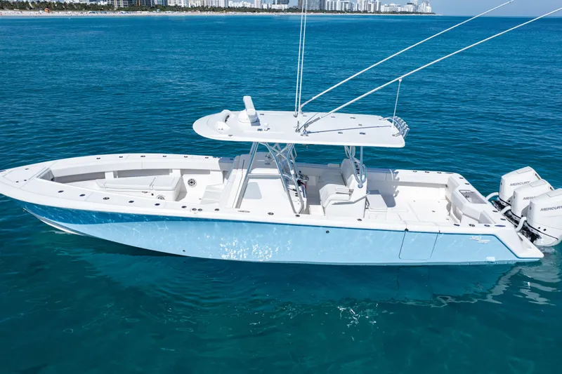 Yacht Photos Pics 2024 SeaVee 390B boat on clear blue water, showcasing sleek design and powerful engines.