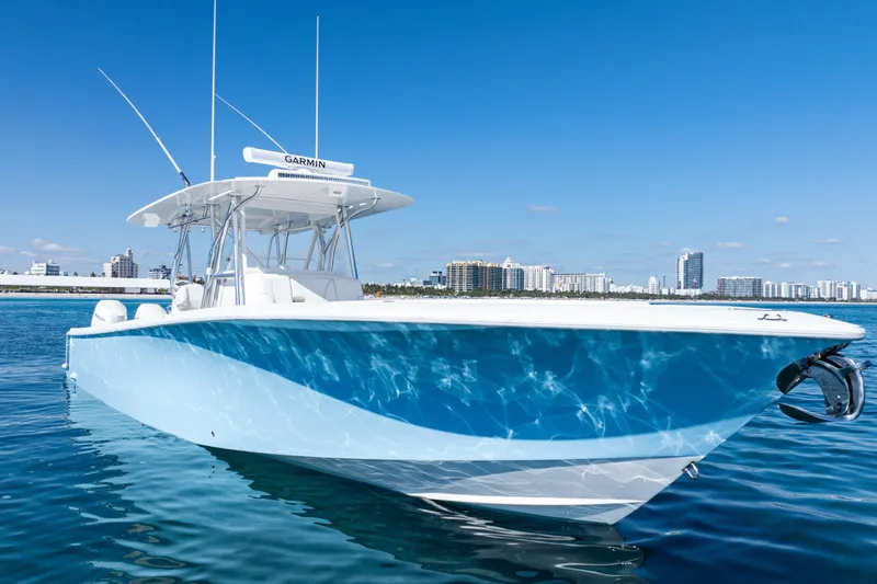  Yacht Photos Pics 2024 SeaVee 390B boat on calm water with city skyline background.