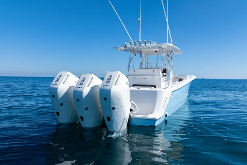 Yacht Photos Pics 2024 SeaVee 390B boat with triple outboard engines on open water.