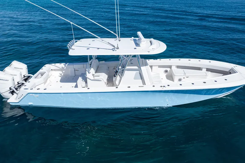  Yacht Photos Pics 2024 SeaVee 390B boat on clear blue water, featuring twin Mercury engines.