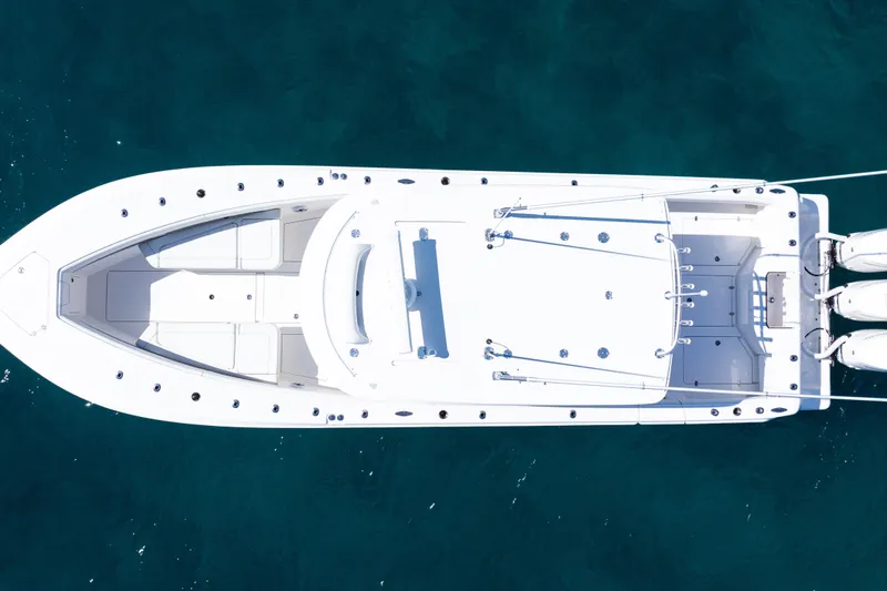  Yacht Photos Pics Aerial view of 2024 SeaVee 390B boat on clear blue water.