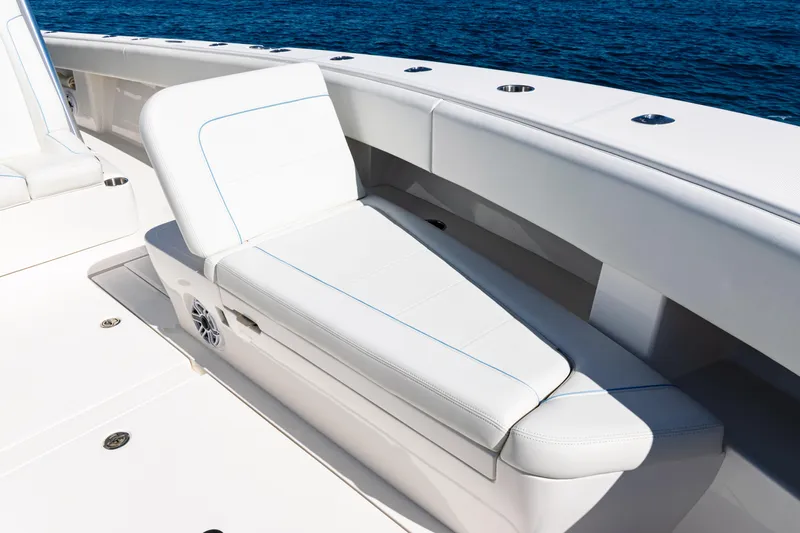  Yacht Photos Pics 2024 SeaVee 390B boat with white cushioned seating, ocean backdrop.