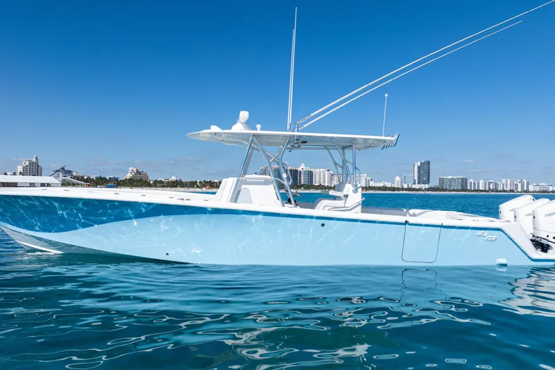  Yacht Photos Pics 2024 SeaVee 390B boat on calm water with city skyline in background.