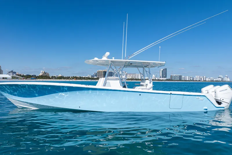  Yacht Photos Pics 2024 SeaVee 390B boat on calm water with city skyline in background.