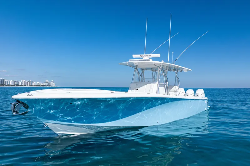  Yacht Photos Pics 2024 SeaVee 390B boat on clear blue ocean with city skyline in background.