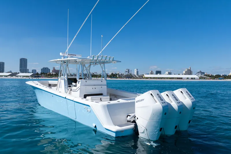  Yacht Photos Pics 2024 SeaVee 390B boat with triple Mercury engines on calm water.
