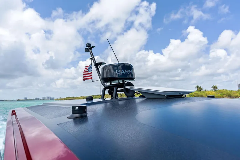 Mana Yacht Photos Pics Modern Maori m54 boat with Garmin equipment, 2025 model, cruising under a cloudy sky.